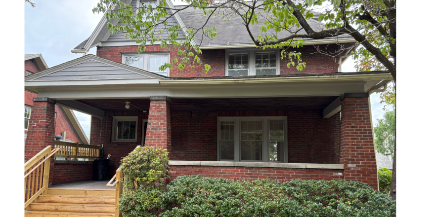 a brick house with a large front porch