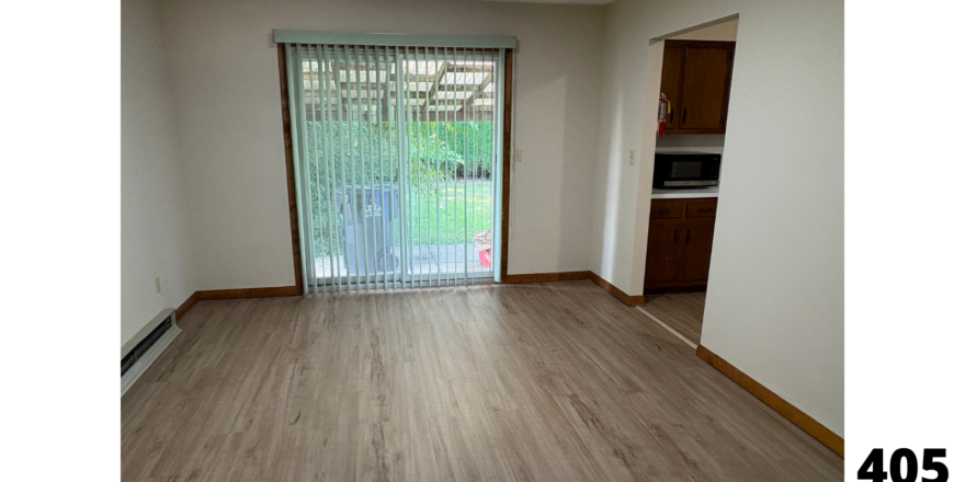 an empty living room with a sliding glass door