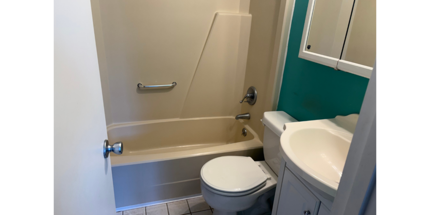 a bathroom with a toilet, sink, and bathtub