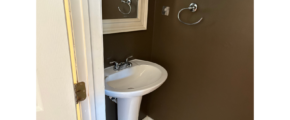 a bathroom with a pedestal sink and mirror