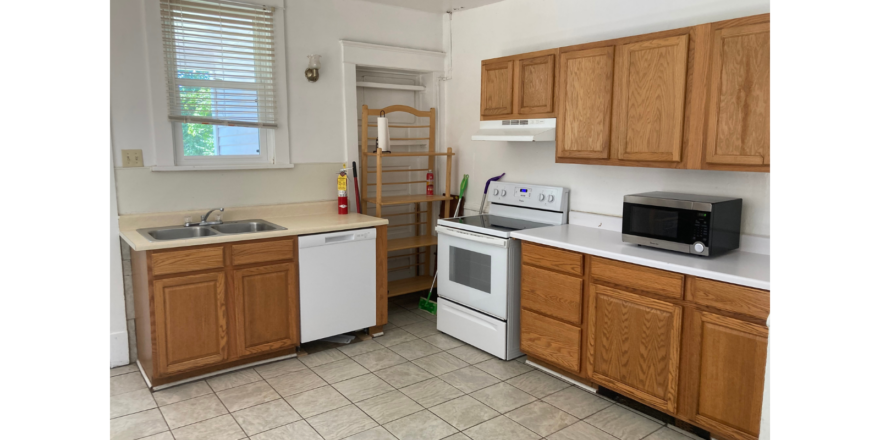 a kitchen with white appliances and wooden cabinets