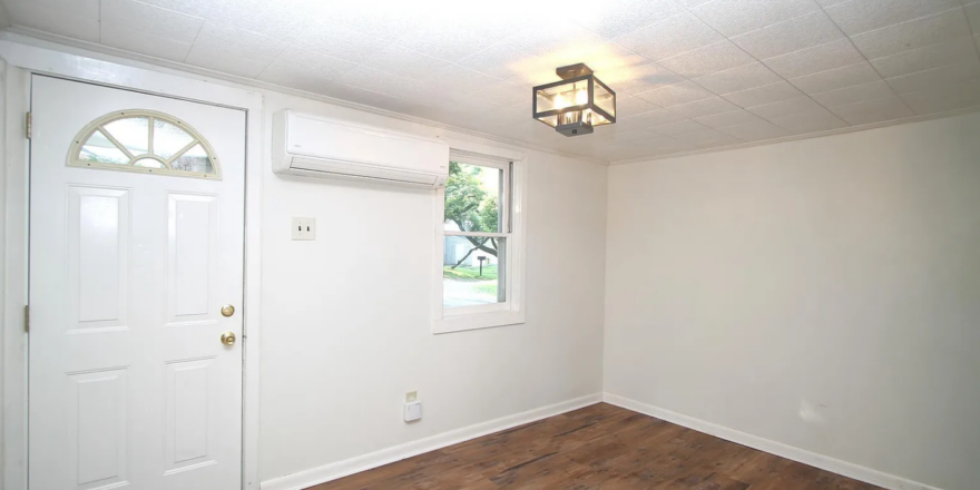 a empty room with a door and a window