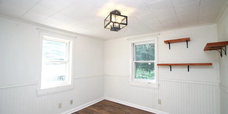 a empty room with wood floors and white walls