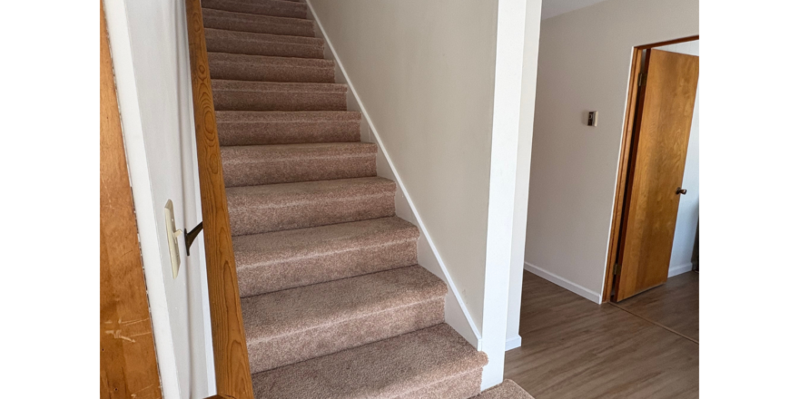 a staircase leading to a second floor bedroom