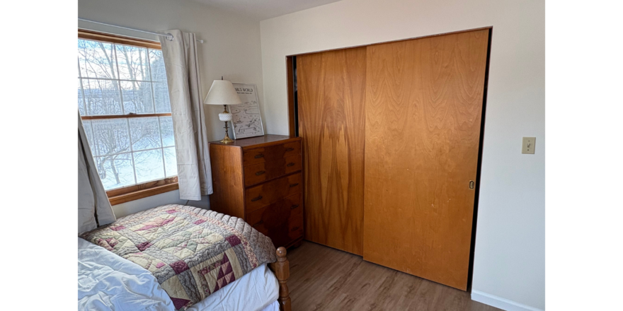 a bedroom with a bed and a closet