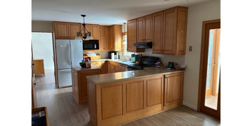 a kitchen with wooden cabinets and stainless steel appliances