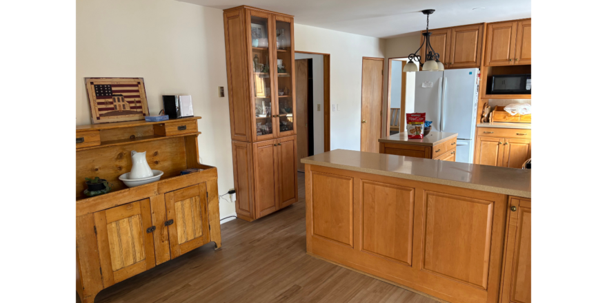a kitchen with wooden cabinets and a refrigerator