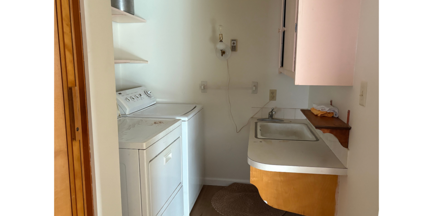 a kitchen with a washer and dryer in it